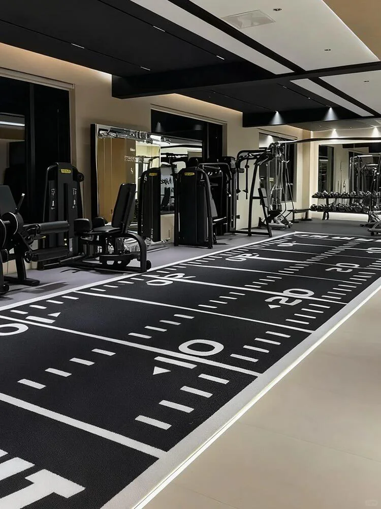 Black gym turf installed with numbered lanes and functional training markings