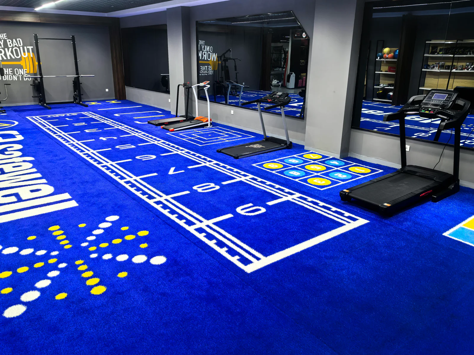 Blue custom gym turf installed with numbers and training markings
